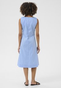 Light blue, sleeveless dress with a square neckline, cinched waist, and flared skirt, featuring a subtle texture and back zip closure.
