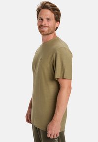 Olive green short-sleeve t-shirt with a crew neckline, smooth texture, and small logo detail on the chest. Suitable for casual wear.