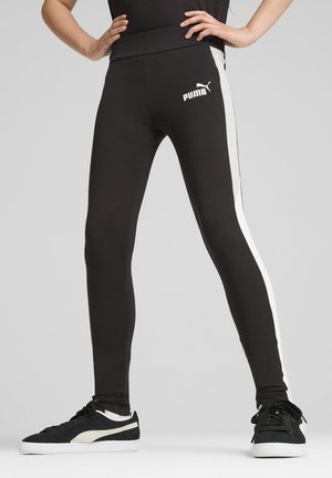 Leggings negros con un diseño ajustado, que presentan franjas laterales blancas y un logo blanco de Puma en la parte delantera. Textura suave y cintura elástica.