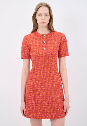 Knee-length fitted dress in textured orange and pink pattern, short sleeves, round neckline with three button closure, and side pockets.