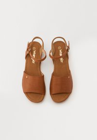 Brune lær sandaler med en bred ribbet stropp over tærne, ankelstropp med spenne og flat såle. Størrelse synlig som 37.