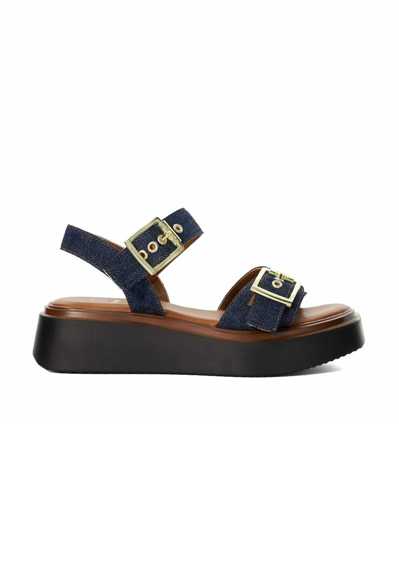 Women's navy denim platform sandal with two gold buckle straps and a black cushioned sole.