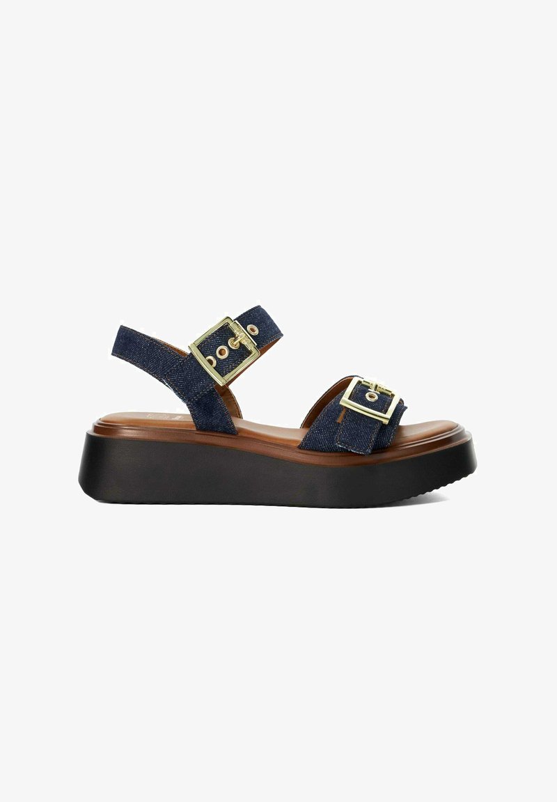 Women's navy denim platform sandal with two gold buckle straps and a black cushioned sole.