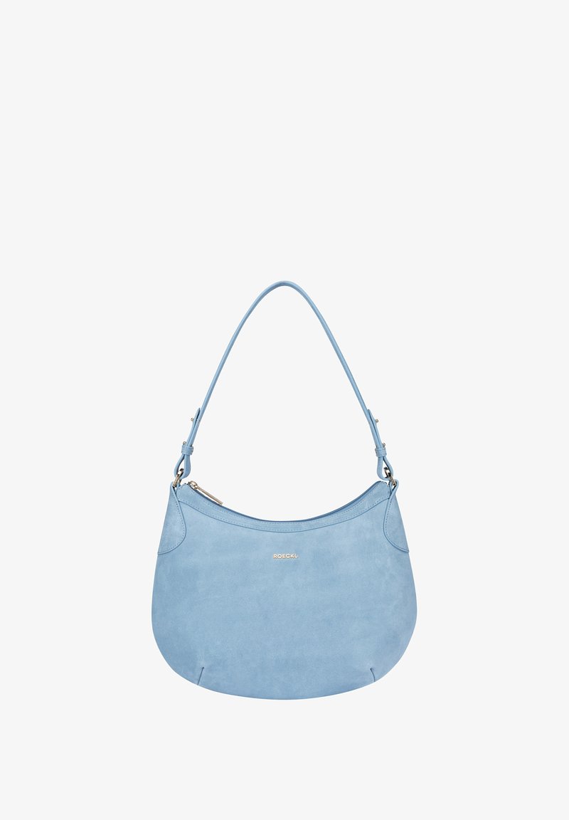 Light blue suede shoulder bag with a curved design, zip closure, and a single adjustable strap. Gold logo accent on the front.