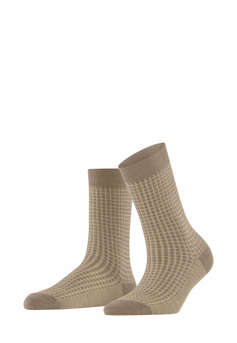Beżowe skarpetki z teksturowanym wzorem siatki, ściągaczem i jednolitymi akcentami w okolicach palców i pięt. Wykonane z miękkiego, elastycznego materiału.