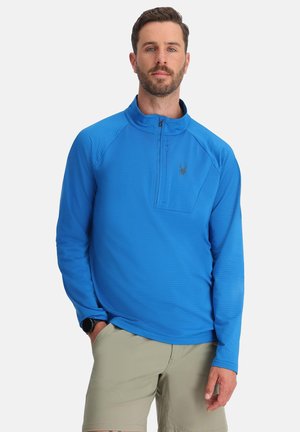 Pullover blu in tessuto testurizzato con zip al collo, dotato di tasca sul petto con zip e piccolo logo nero sulla parte sinistra del petto.