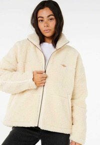 Crème fleece jack met een hoge kraag, ritssluiting en zijzakken. Heeft een zachte textuur en een minimalistisch ontwerp.