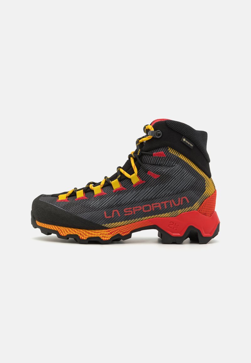 High-top hiking shoe featuring a black synthetic upper with red and yellow accents, a textured finish, rubber sole, and reinforced toe cap.
