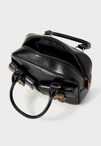Black leather handbag with a structured shape, gold hardware accents, and a top zipper. Features dual handles and textured surface.