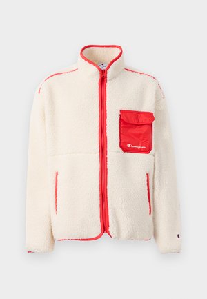 Cremefarbene Fleecejacke mit roten Akzenten, hohem Kragen, durchgehendem Reißverschluss und einer Vorderasche. Sie zeichnet sich durch ihre weiche Textur und das schlanke Design aus.