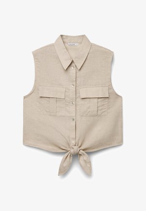 Top corto beige senza maniche con bottoni, colletto, due tasche frontali con patta e nodo annodato in vita.