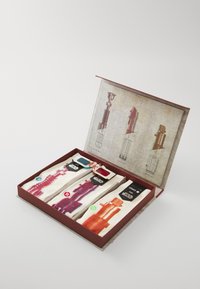 Caja de regalo temática en rojo y marrón que contiene calcetines temáticos con diseños de sables de luz en azul, rojo y verde sobre un fondo de tela beige.