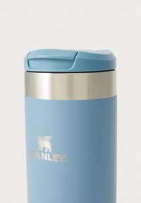 Stanley termosmugg, blå matt finish med ett stainless steel-band. Utrustad med ett tätt förslutet ljusblått lock och präglat logotyp.