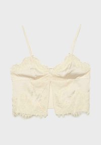 Camisole en dentelle crème avec fines bretelles, détail de boutons au centre devant, et ourlet ainsi que bords en dentelle festonnée.