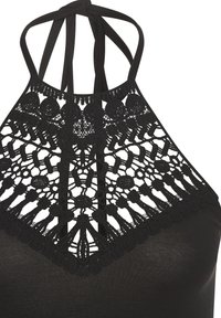 Black halter top featuring a detailed lace neckline with circular and floral patterns, adjustable straps, and a smooth fabric body.