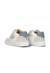 Baskets blanches et beiges en matériaux suédés et en cuir, avec des bandes Velcro et un accent bleu clair sur le talon. Semelle en caoutchouc avec une texture antidérapante.