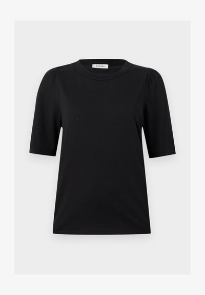 Chemise noire à manches courtes avec épaules légèrement bouffantes et encolure ronde, présentée sur un fond gris clair uni.