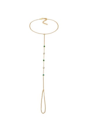 Bracelet délicat en chaîne d'or pour la main avec fermoir ajustable et pierres précieuses rondes vertes et transparentes le long de la chaîne de liaison.