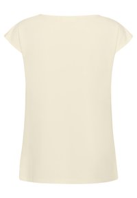 T-shirt à manches courtes en tissu beige clair et doux, avec une coupe décontractée et un col arrondi, présentant des coutures nettes et sans embellissements supplémentaires.