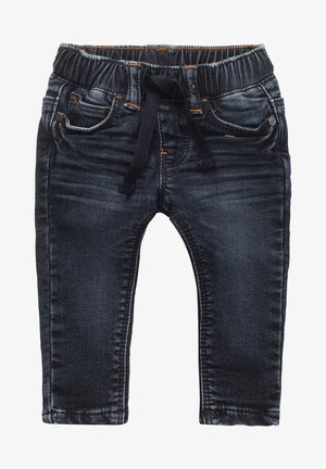 Jean denim bleu marine pour tout-petit avec taille élastique et cordon noir, doté de poches avant et arrière ainsi que de surpiqûres orange.