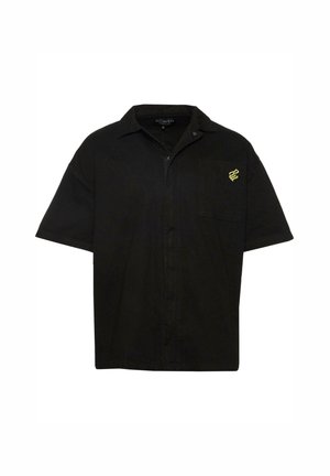 Black short-sleeve shirt made of cotton with a front pocket. Features a yellow snake logo on the chest and a front button closure.