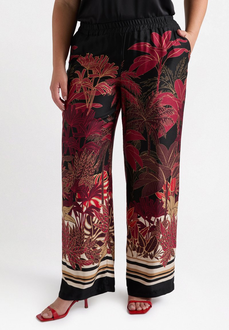 Wide-leg patterned pants in black, featuring red and gold floral designs. Elastic waistband with side pockets. Accented with horizontal stripes at the hem.
