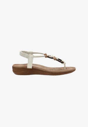 Sanda blanca con tiras, equipada con una plantilla acolchada, que presenta detalles trenzados en beige y negro, y una suela flexible de goma marrón. Diseño plano.