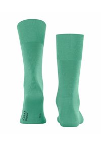 Minzgrüne Socken mit gerippten Bündchen und glatter Textur. Mit FALKE-Branding an der Sohle. Knöchellanges Design.