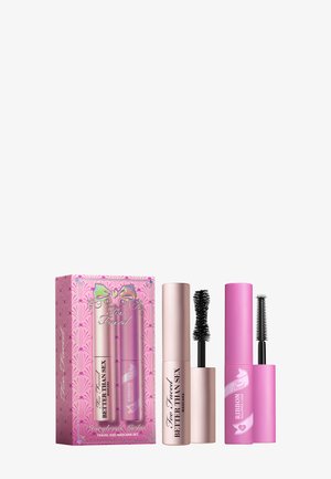 Travel-size mascara set featuring a pink and metallic gold box, two tubes: a pink tube with a bristle brush and a gold tube with a fiber brush.