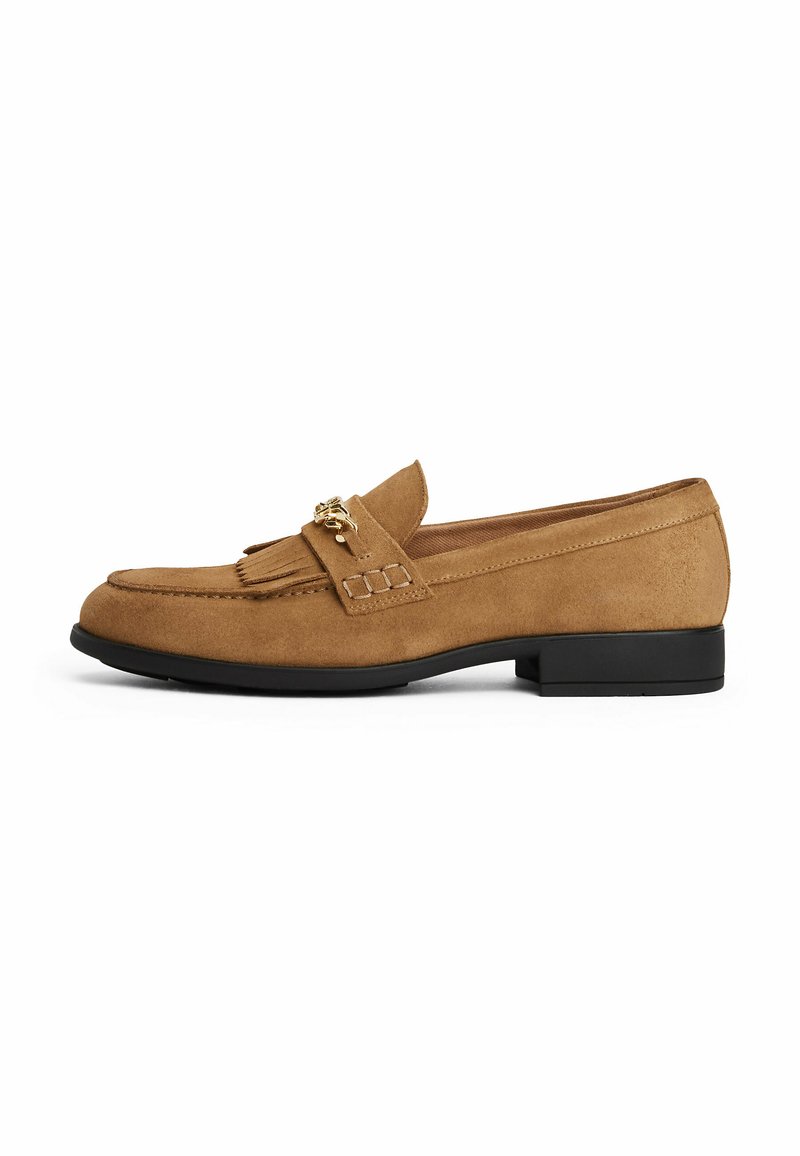 Tan suede loafer with a front tassel detail and gold hardware accents. Features a rounded toe and a low black sole.