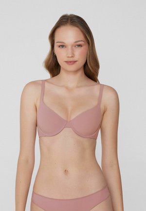 Roze gevormde bh met verstelbare bandjes. Gemaakt van gladde stof, met een klassiek onderdraadontwerp. Eenvoudig en minimalistisch.