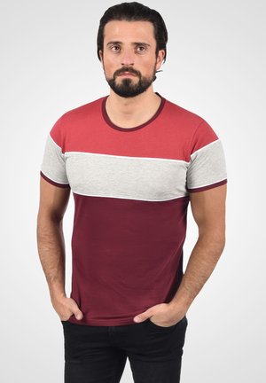 Red and gray T-shirt with a horizontal color-block design, short sleeves, and a round neckline. Soft cotton material.