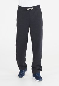 Mörkgrå sweatpants i mjukt tyg, med dragsko i midjan, sidofickor och avslappnad passform. Lämpliga för avslappnad användning.