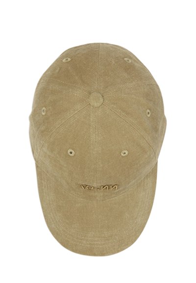 Beige corduroy baseball cap with embroidered text on front panel, six ventilation eyelets, and visible stitching on panels and brim.