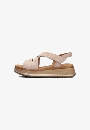Beige suede sandal with crisscross straps, low platform design, and wood-textured wedge sole. Features a cushioned footbed and rubber outsole.
