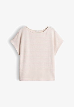 Top a maniche corte beige chiaro con scollo rotondo, vestibilità ampia e tessuto strutturato, posato in piano su uno sfondo bianco.