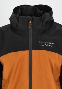 Black and orange waterproof jacket with high collar, zipper closure, and logo. Features smooth texture and contrasting color blocks.