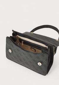 Borsa nera con esterno texturizzato, dettagli in metallo dorato e una tasca interna con zip. L'interno presenta una fodera a fantasia e più scomparti.