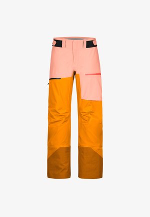 Two-tone outdoor pants with pink upper section, orange lower legs, reinforced brown cuffs, and zippered pockets on white background.