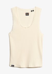 Geribbelde tanktop in crème met een gegolfde kantafwerking rond de halslijn en armsgaten. Voorzien van een klein zwart label aan de zoom.