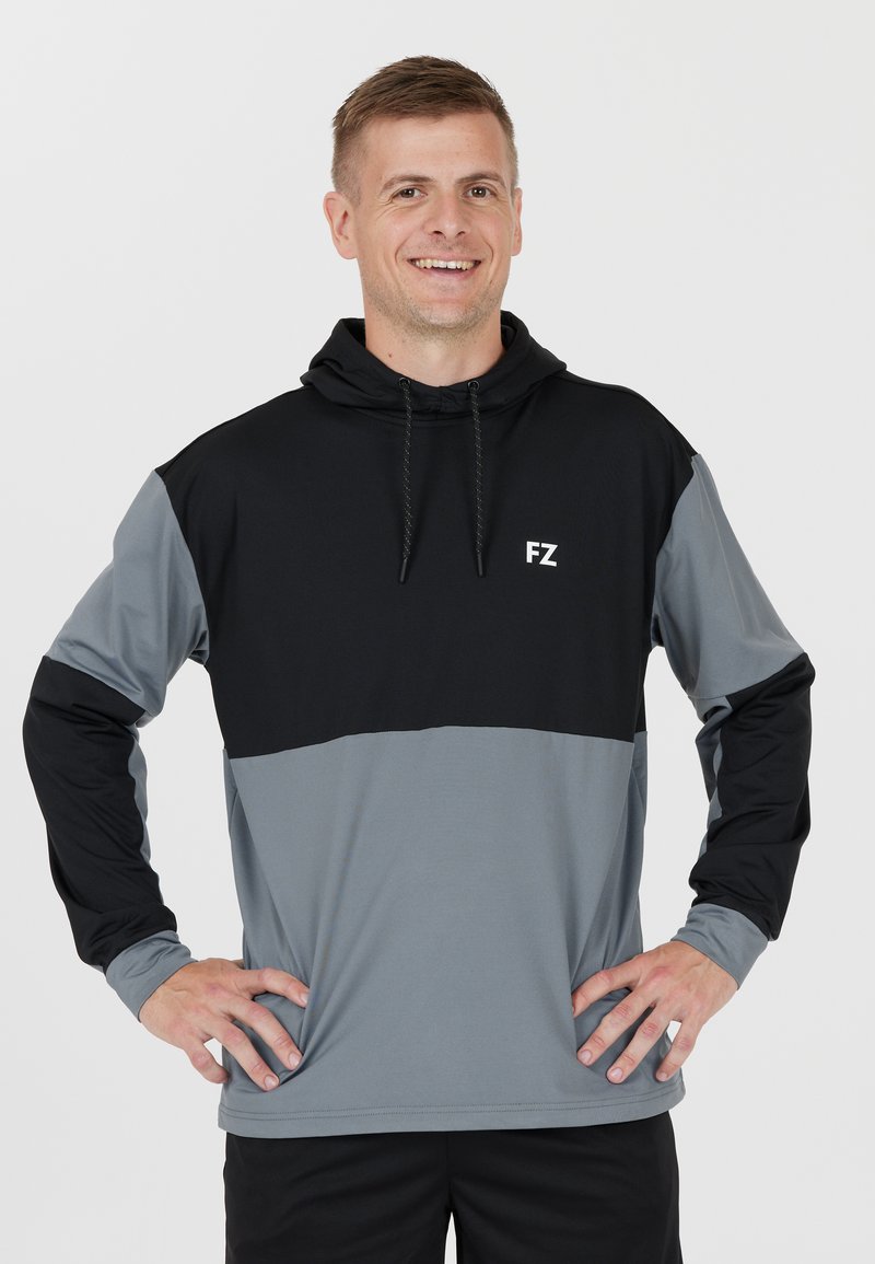 Hoodie med lång ärm i svart och gråa färgblock. Har lättvikts tyg, framsidan med logo och justerbara dragkedjor i huvan.