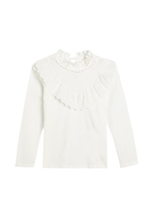 Haut blanc à manches longues avec col montant à volants et détail à volants orné de dentelle sur la poitrine et les épaules.