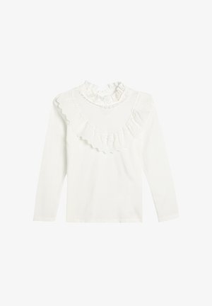 Biała bluzka z długim rękawem, z falbaniastego, wysokiego kołnierza i ozdobiona koronkową falbanką na wysokości klatki piersiowej oraz ramion.