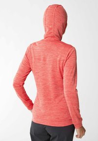 Hoodie a maniche lunghe rosso melangiato con un design aderente, tessuto testurizzato e cappuccio avvolgente. Presenta dettagli delle cuciture lungo le spalle e le maniche.
