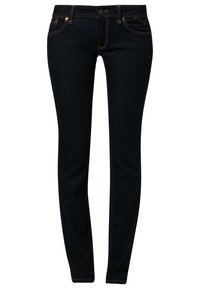 Jeans ajustados de color azul oscuro hechos de mezclilla, con cinco bolsillos, costuras amarillas y un cierre frontal con botón.