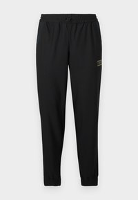 Μαύρο αθλητικό παντελόνι με υφή υφάσματος, ελαστική μέση, κορδόνι, κωνικά πόδια και μικρό χρυσό λογότυπο στην αριστερή πλευρά.