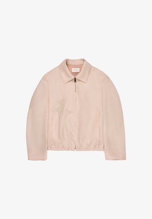 Beige jas met ritssluiting en kraag, elastische zoom, subtiele bloemenborduursels aan de linkerkant, en twee verticale voorzakken.