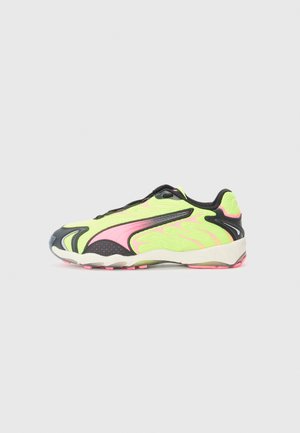 Sneaker with a mesh upper in bright yellow-green, black accents, and pink detailing. Features a textured outsole and rounded toe.