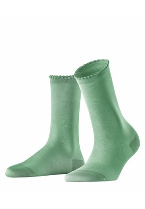 Grüne Knöchelsocken mit einem strukturierten Muster aus dezent erhobenen Punkten, gewelltem Rand an der Oberseite sowie verstärktem Fersen- und Zehenteil für Langlebigkeit.