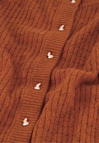 Roodbruine gebreide cardigan met ribbelstructuur en ruitpatronen, voorzien van gouden knopen aan de voorkant voor sluiting.